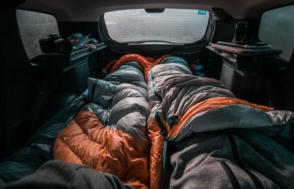 Zwei ausgebreitete Schlafsäcke in einem Auto mit beschlagenen Fenstern